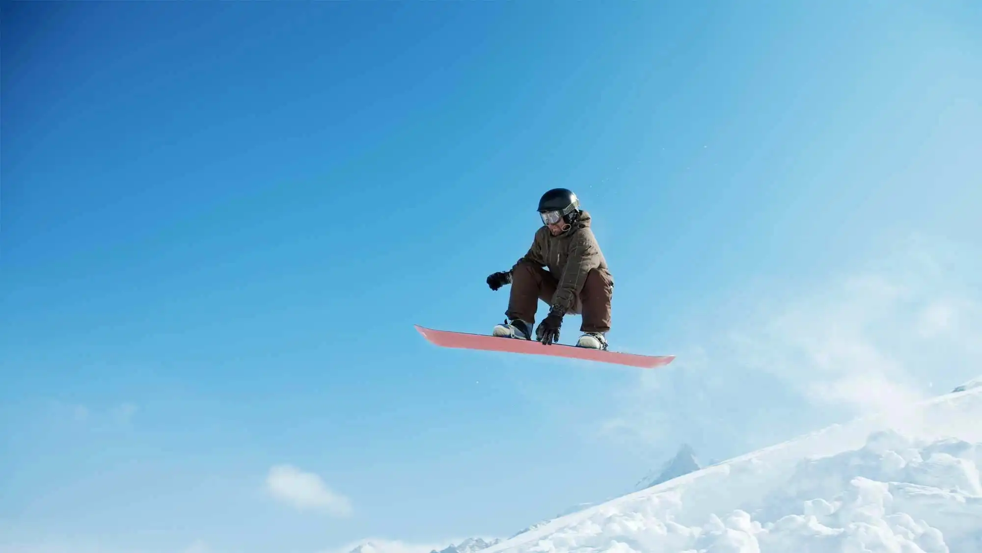 man jumping on a snowboard